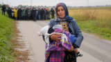 Fatima from Syria (front) walks ahead of other migrants as they make their way on foot after crossing the Croatian-Slovenian border, in Rigonce, Slovenia, October 22, 2015.