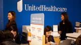 Representatives speak with customers at a UnitedHealthcare store in Queens, New York.