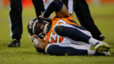 Strong safety David Bruton of the Denver Broncos lies on the ground in pain after a play that would force him out of a game against the Oakland Raiders with a reported concussion on Dec. 28, 2014, in Denver.