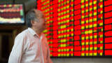 An investor observes stock market at a stock exchange hall in Nanjing, Jiangsu province, China.