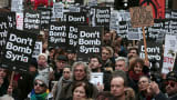 Demonstrators listen to speakers at a rally against taking military action against Islamic State in Syria, held outside Downing Street in London, November 28, 2015.