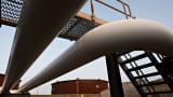 Pipelines run toward oil storage tanks at the Enbridge Cushing storage terminal in Cushing, Oklahoma.