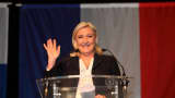 French Far-Right National Front President Marine Le Pen waves and smiles at the end of her speech after the announcement of the results of the first round of the regional election on December 6, 2015.