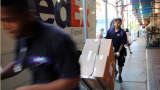 FedEx employees make deliveries in Manhattan.