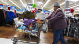 A woman pushes her shopping cart through a Walmart store in Secaucus, New Jersey.