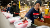Employees assemble food containers on a production line at the Newell Rubbermaid factory in Mogadore, Ohio.