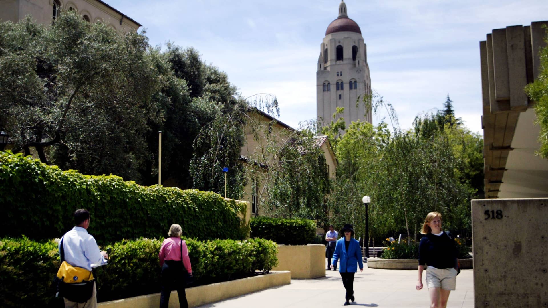 Students walk past Stanford University's Graduate School of Business in Stanford, California.