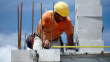 A construction worker builds a wall of a home at a Lennar development in Doral, Florida.