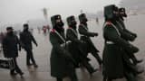 Paramilitary policemen wearing masks march on a cold morning amid heavy smog at Tiananmen Square in Beijing.