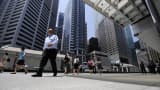 Office workers walk through the central business district of Singapore