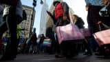 Pedestrians carry shopping bags on Black Friday through Herald Square in New York.