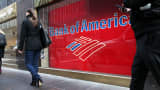 Pedestrians pass in front of a Bank of America branch in New York City.