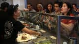 Chipotle restaurant workers fill orders for customers in Miami, Florida.