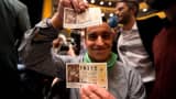 A man shows his tickets as he attends the draw of Spain's Christmas lottery named 'El Gordo' (The Fat One) at the Teatro Real in Madrid, on December 22, 2015.