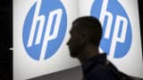 A man passes a Hewlett Packard display at a technology conference
