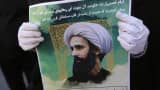 An Iranian woman holds a portrait of prominent Shiite Muslim cleric Nimr al-Nimr during a demonstration against his execution by Saudi authorities, on January 3, 2016.
