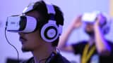 People play with virtual reality head gear 'Gear VR' of Oculus during the Tokyo Game Show.