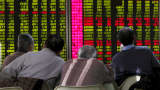 Men look an electronic board showing stock information at a brokerage house in Beijing, China, January 5, 2016.