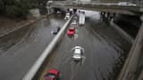 Vehicles drive on the flooded Freeway 5 after an El Niño-strengthened storm brought rain to Los Angeles on Jan. 6, 2016.