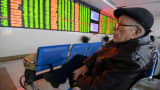 An investor observes stock prices on Jan. 7, 2016, in Fuyang, China.
