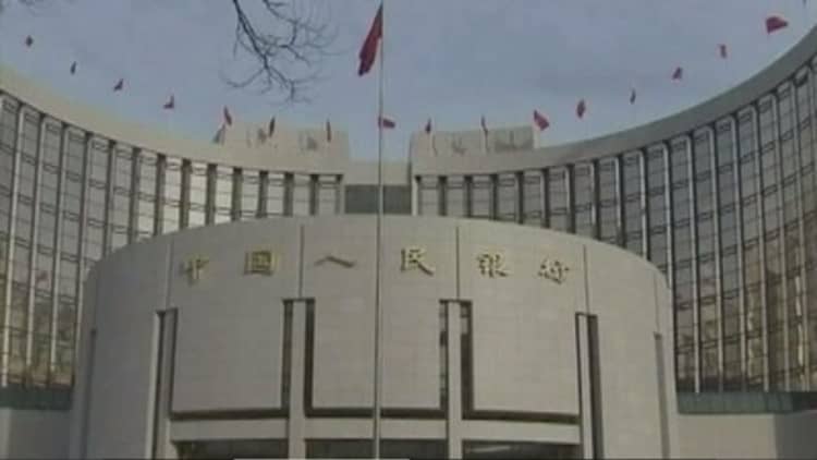China to further liberalize the yuan, nudges rate higher