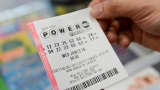 A person in New York holds a Powerball ticket