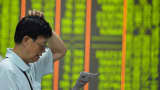 An investor watches the electronic board at a stock exchange hall in Hangzhou, China.