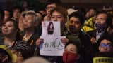 A supporter of Taiwan's Democratic Progressive Party (DPP) holds up a placard of K-pop artist Chou Tzu-yu.