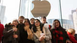 Customers pose for a photograph as an Apple store opens on January 16, 2016 in Nanjing, China.