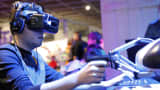 A gamer plays a game with the virtual reality head-mounted display 'Oculus Rift'