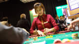 A dealer handles gaming chips at a baccarat table inside the Venetian Macau resort and casino, operated by Sands China Ltd., a unit of Las Vegas Sands Corp., in Macau, China.