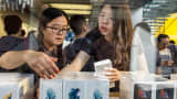 Customers purchase at an Apple store in Beijing, China.