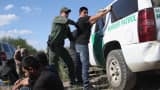 A U.S. Border Patrol officer body searches an undocumented immigrant after he illegally crossed the U.S.-Mexico border and was caught near Rio Grande City, Texas.