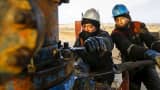 Workers carry out maintenance at an oil well operated by a subsidiary of the KazMunayGas Exploration Production JSC in Kazakhstan.