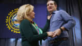 Heidi Cruz adjusts the collar of her husband Republican presidential candidate Sen. Ted Cruz's (R-TX) shirt as he takes the stage during a campaign town hall meeting at the Crossing Life Church February 2, 2016 in Windham, New Hampshire.