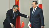 Japan's Foreign Deputy Minister Shinsuke Sugiyama (L) gestures as he welcomes China's Assistant Minister of Foreign Affairs Liu Jianchao (R) prior to the 13th round of Japan-China Security Dialogue at the Foreign Ministry in Tokyo on March 19, 2015.