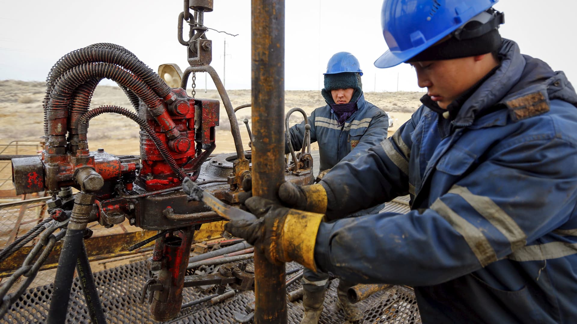 Workers at an oil well operated by a subsidiary of the KazMunayGas Exploration Production JSC in Kazakhstan, January 21, 2016.