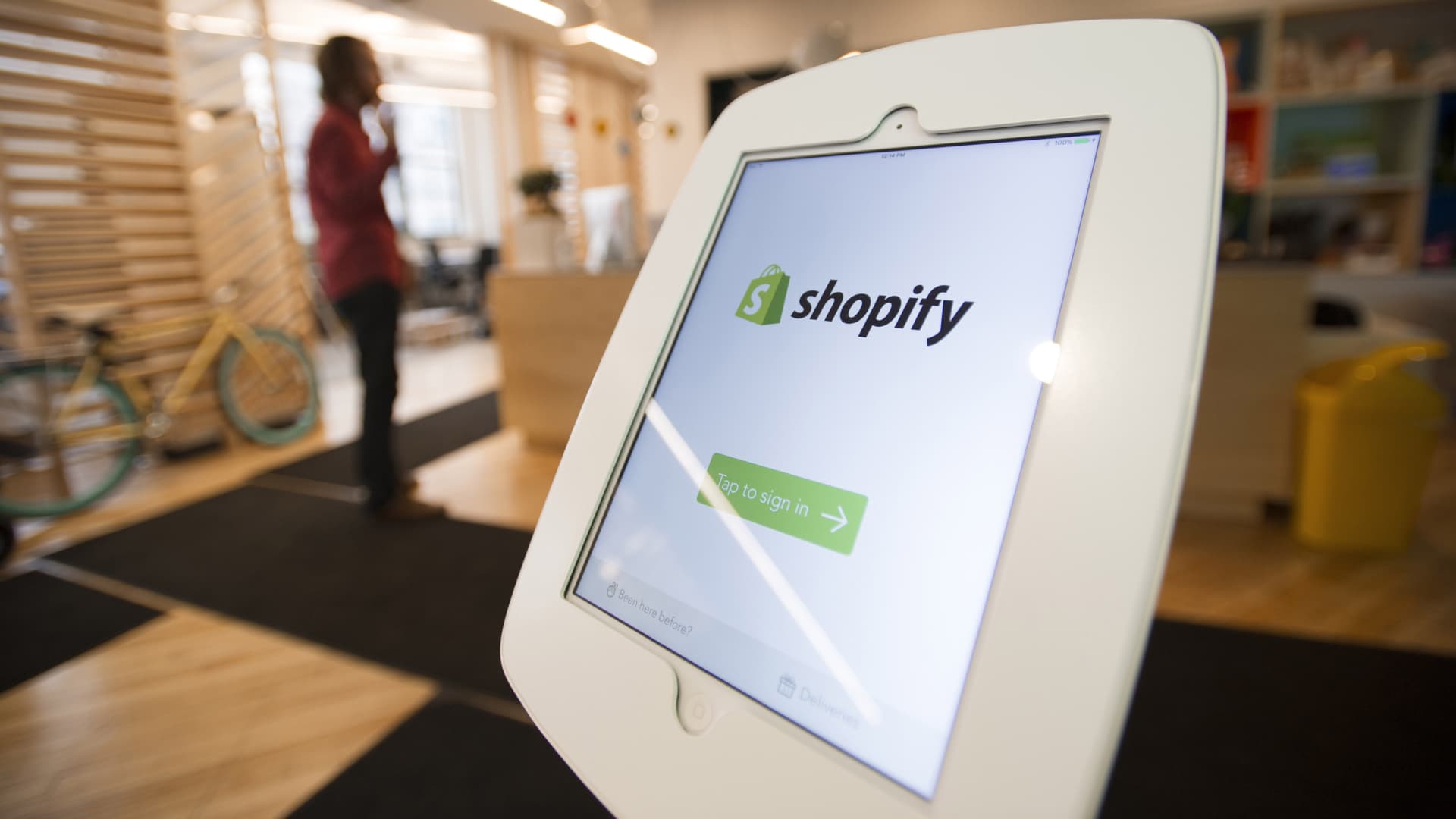 An Apple iPad with the Shopify app is displayed at the entrance to the company's headquarters in Toronto, Ontario.
