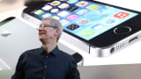 Apple CEO Tim Cook looks on at an Apple Store on September 20, 2013 in Palo Alto, California. Apple launched two new models of iPhone: the iPhone 5S, which is preceded by the iPhone 5, and a cheaper, paired down version, the iPhone 5C.