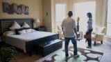 Prospective home buyers view a bedroom while touring a house for sale in Helotes, Texas.