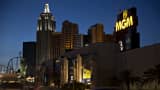 Vehicles drive past the New York-New York Hotel & Casino, left, and MGM Resorts International Grand Hotel & Casino in Las Vegas, Nevada.