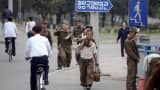 "Soldier-builders" and civilians walk in central Pyongyang, North Korea last October.