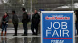 Job seekers wait in line to register for a job fair