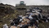 A compactor packs down trash to be covered with fresh dirt at the Defiance County Landfill in Defiance, Ohio, U.S., on Wednesday, Dec. 2, 2015.