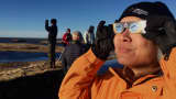 People watch the solar eclipse on march 20, 2015 in Höfn, South Iceland.