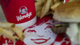 The Wendy's Co. logo is seen on a cup displayed for a photograph at a restaurant location in Daly City, California.