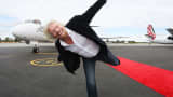 Sir Richard Branson poses in front of an aircraft at Perth Airport on May 7, 2013 in Perth, Australia.