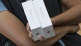 A customer holds boxes of the new Apple iPhone 6S while waiting to check out at an Apple store in Palo Alto, Calif.