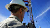 An oil worker stands by a rig near Williston, North Dakota.