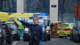 A police woman gestures in front of ambulances at the scene of a blast outside a metro station in Brussels, in this still image taken from video on March 22, 2016.